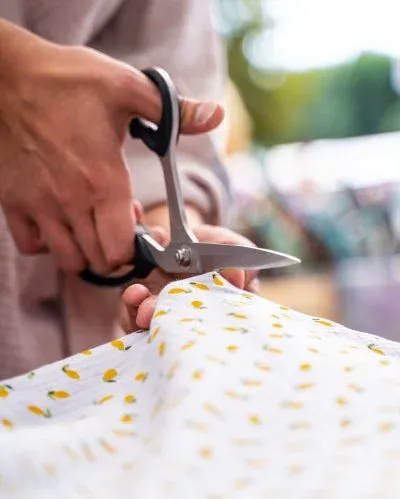 Stoff wird mit der Schere zugeschnitten
